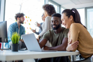 Peers looking at a laptop together